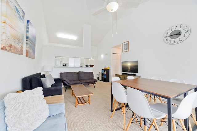 interior space with light carpet, ceiling fan, and high vaulted ceiling