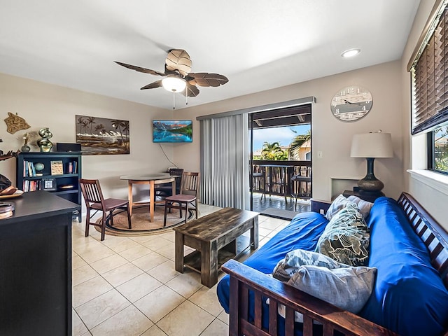 living room featuring light tile patterned floors, plenty of natural light, and a ceiling fan