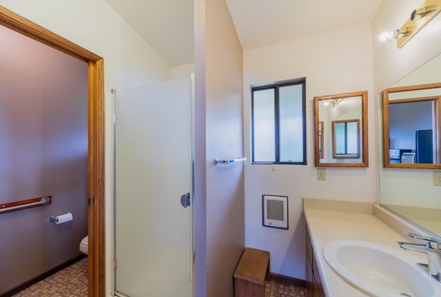 full bathroom with baseboards, vanity, toilet, and walk in shower