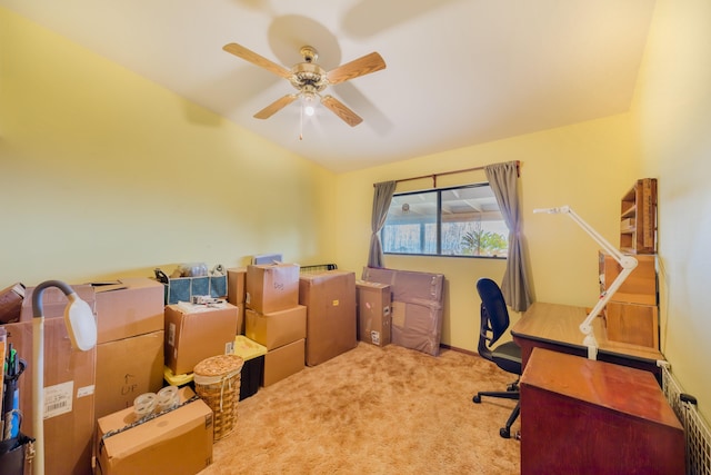 office space featuring light carpet, vaulted ceiling, and a ceiling fan