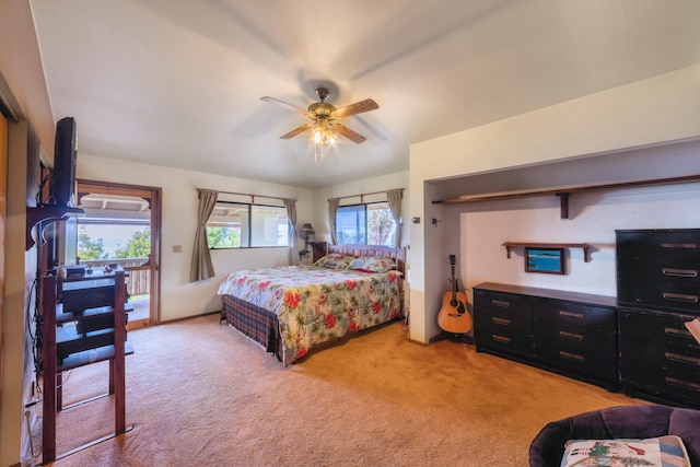 bedroom with access to exterior, light colored carpet, and ceiling fan