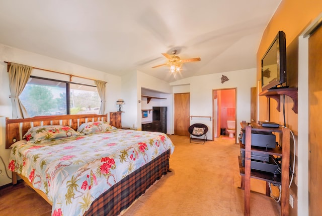 bedroom with ceiling fan, vaulted ceiling, and light colored carpet