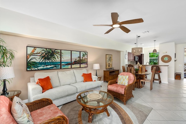 living room with light tile patterned floors, ceiling fan, and visible vents