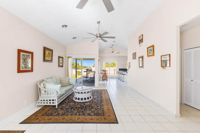 living room with vaulted ceiling, baseboards, and light tile patterned floors