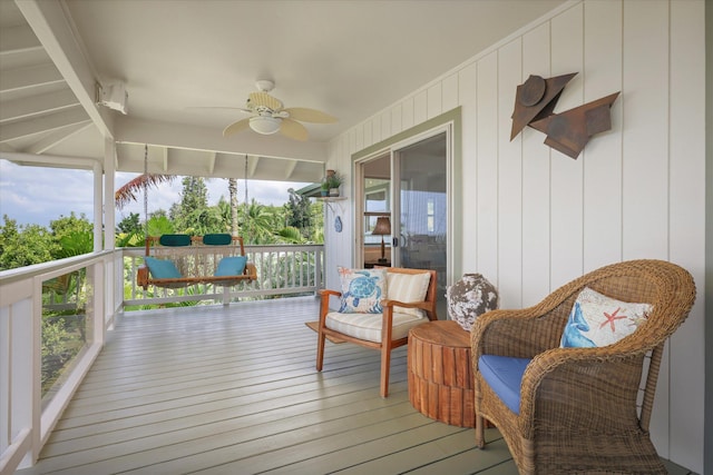 wooden terrace featuring ceiling fan