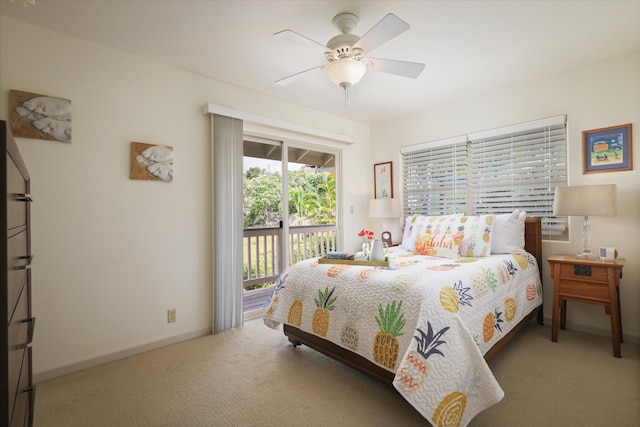 carpeted bedroom with access to exterior, ceiling fan, and baseboards