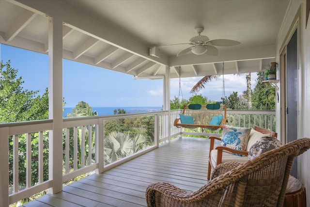 wooden terrace featuring a water view and a ceiling fan