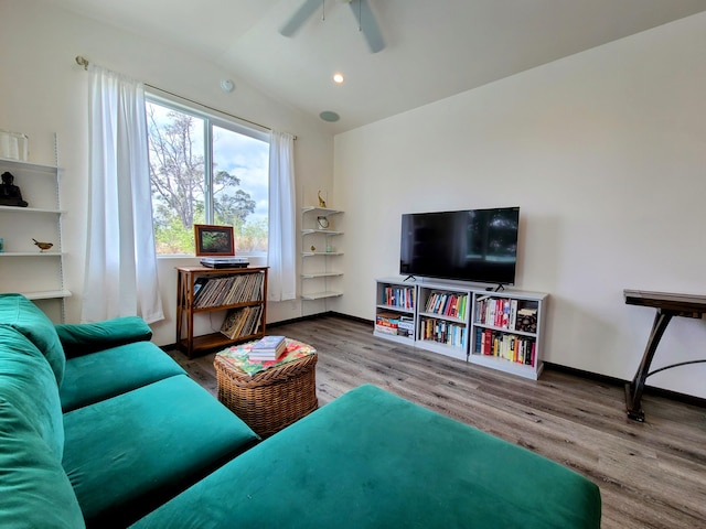 living area featuring baseboards, vaulted ceiling, wood finished floors, and recessed lighting