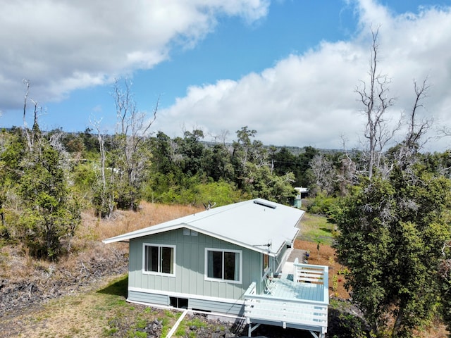 exterior space featuring board and batten siding and a wooden deck