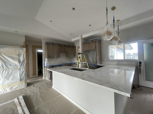 kitchen with brown cabinets, a peninsula, light stone countertops, vaulted ceiling, and hanging light fixtures