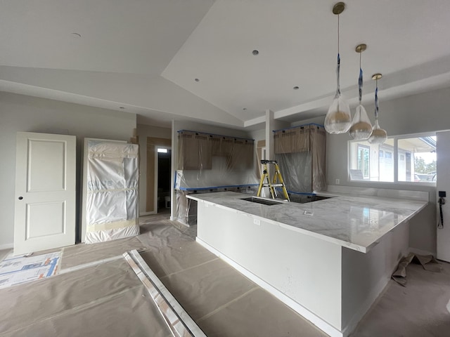 kitchen with lofted ceiling, light stone counters, brown cabinets, and pendant lighting