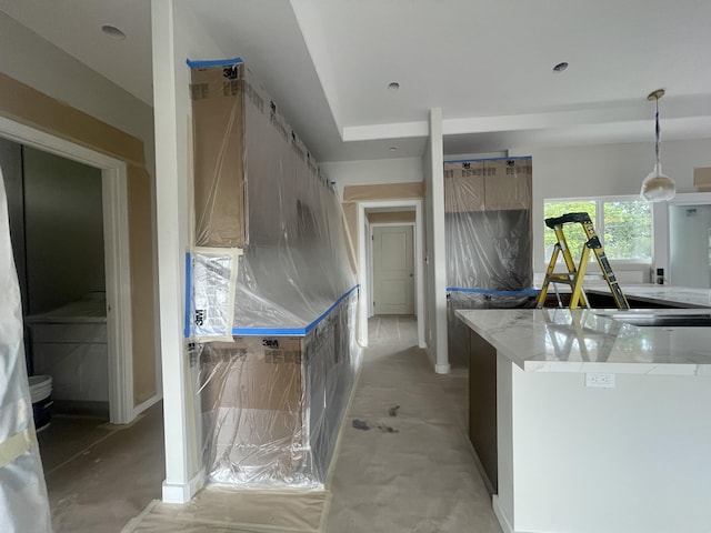 kitchen with decorative light fixtures and concrete flooring