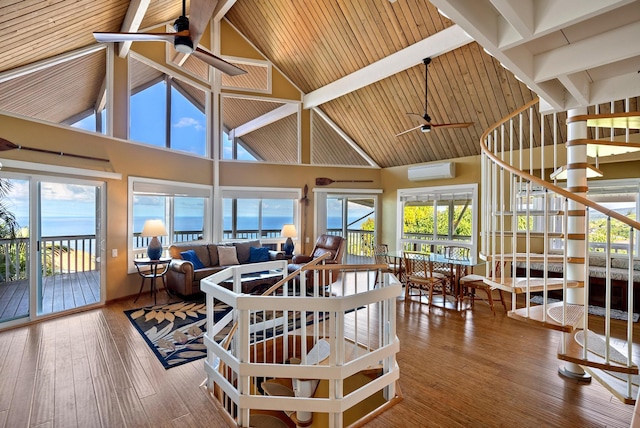 dining space featuring beam ceiling, a wall mounted air conditioner, and hardwood / wood-style floors