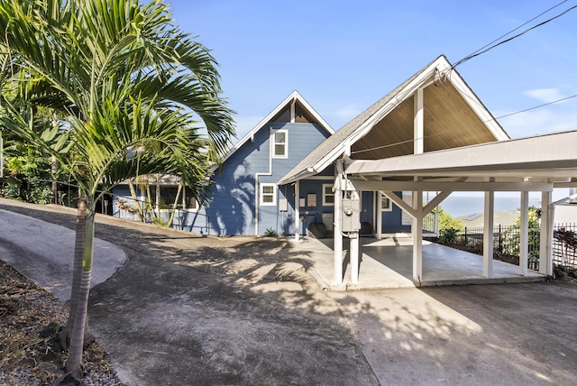 view of front of property with a patio area and fence