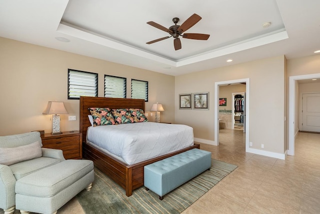 bedroom with baseboards, a tray ceiling, and ceiling fan