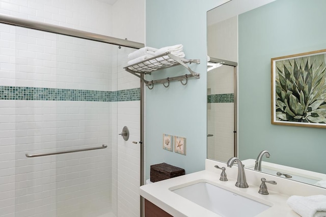 bathroom with a shower stall and vanity