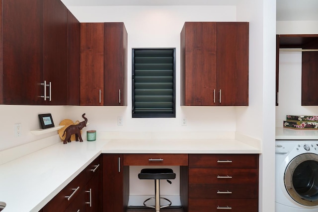 clothes washing area featuring washer / dryer and cabinet space