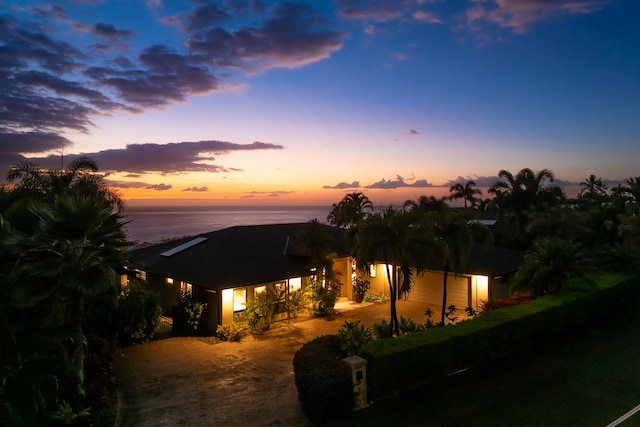 rear view of house featuring a water view