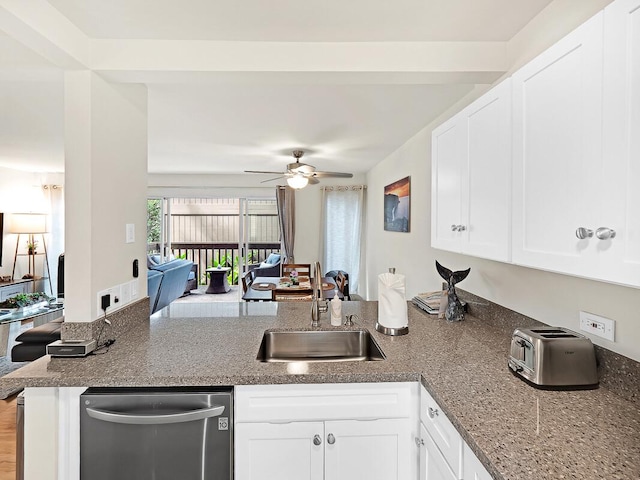 kitchen with white cabinetry, a peninsula, ceiling fan, a sink, and stainless steel dishwasher