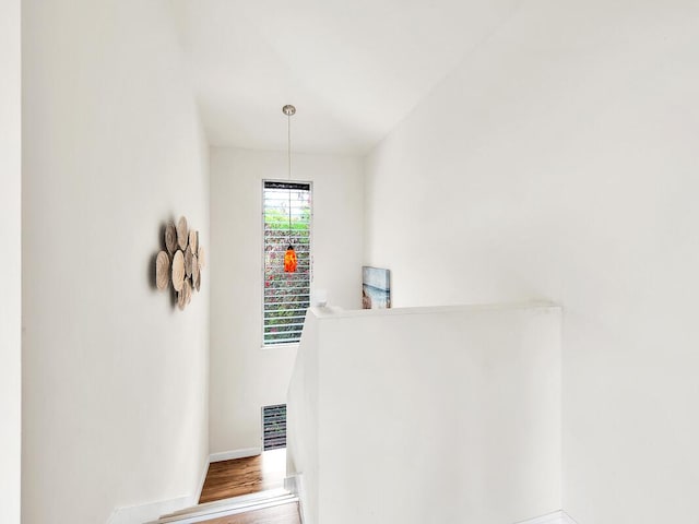 stairway featuring baseboards and wood finished floors