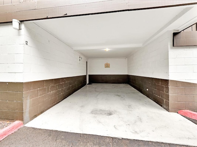 garage with concrete block wall