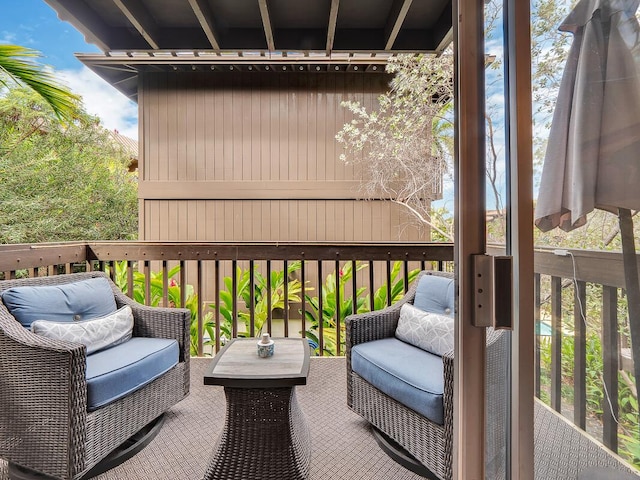 wooden terrace with an outdoor living space