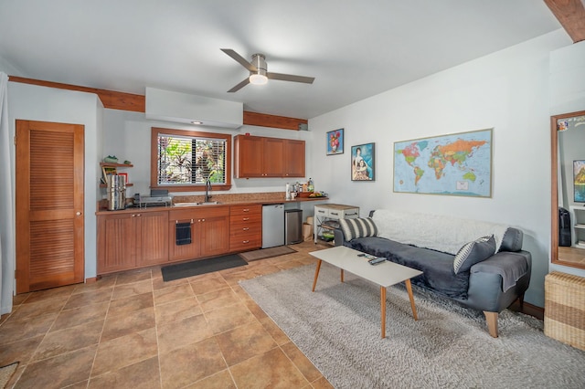 kitchen with radiator, stainless steel dishwasher, brown cabinetry, open floor plan, and a sink