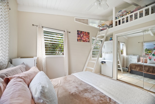 bedroom with vaulted ceiling with beams, a closet, multiple windows, and wooden ceiling