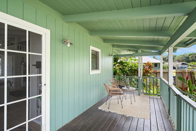 wooden deck featuring fence and a porch