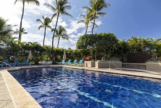 view of swimming pool featuring a patio area and fence