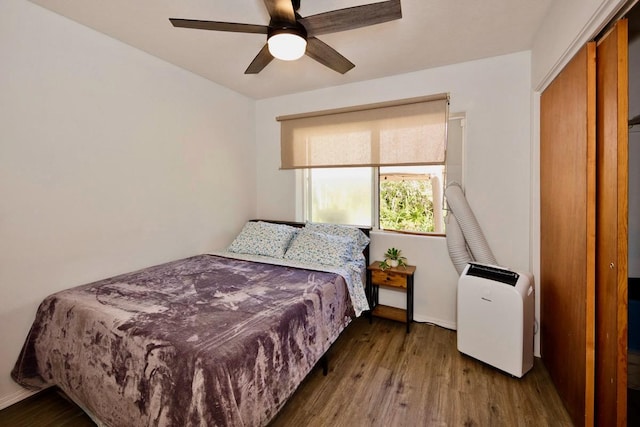 bedroom with ceiling fan and wood finished floors