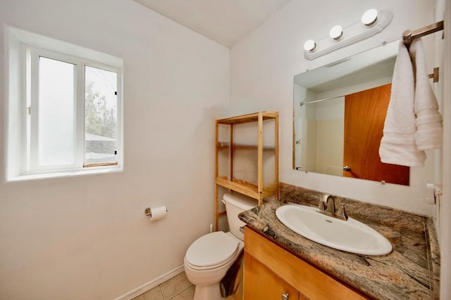 full bath with tile patterned floors, toilet, vanity, baseboards, and walk in shower