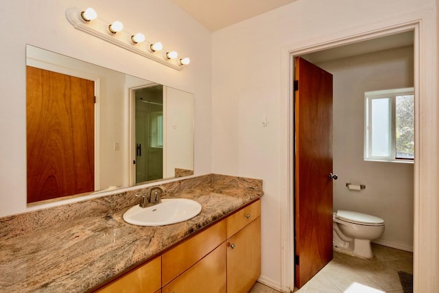 bathroom featuring vanity, toilet, and tile patterned floors