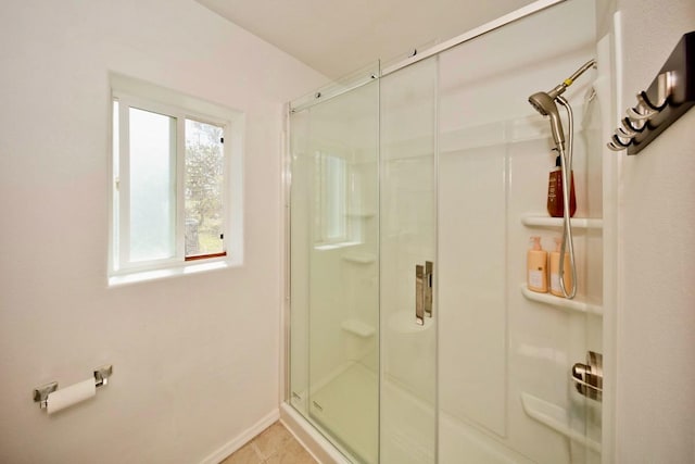 full bathroom with tile patterned flooring, a shower stall, and baseboards