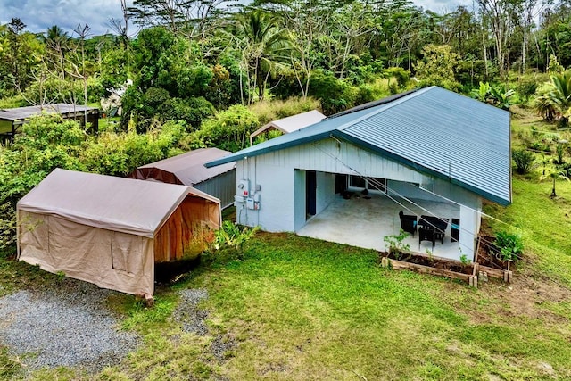 exterior space featuring a wooded view