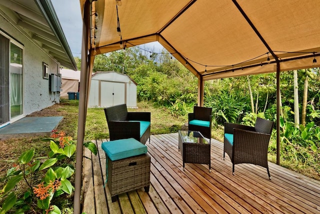 wooden terrace featuring an outdoor structure and a shed