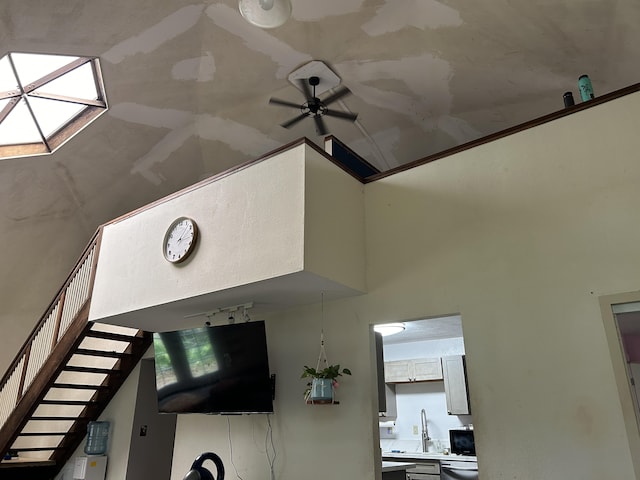 detailed view of ceiling fan, rail lighting, and dishwasher
