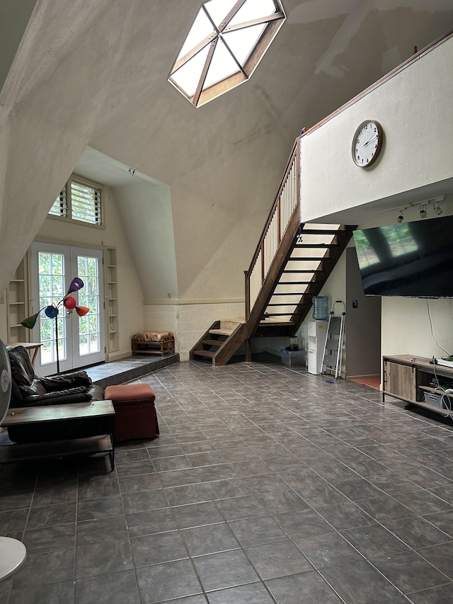 interior space featuring high vaulted ceiling and stairs