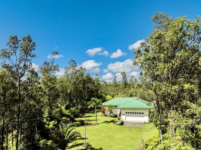 exterior space featuring a wooded view