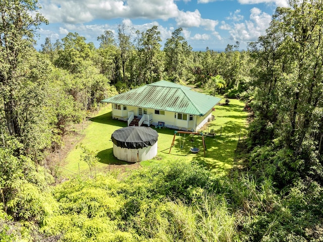 bird's eye view with a wooded view