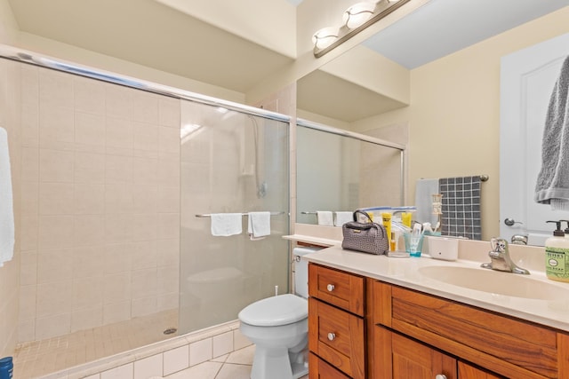 bathroom featuring a stall shower, vanity, toilet, and tile patterned floors