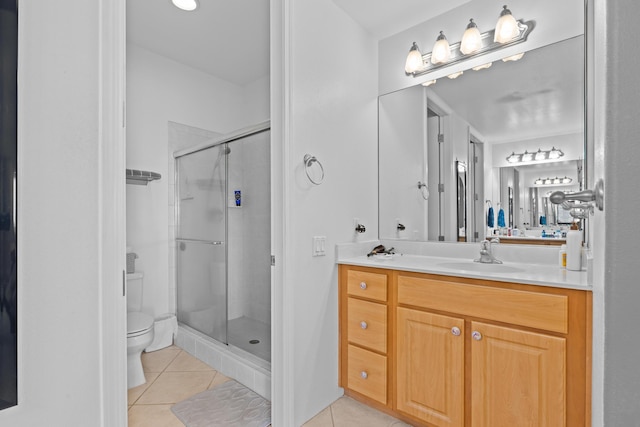 full bathroom featuring vanity, a shower stall, toilet, and tile patterned floors