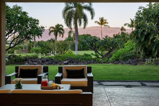 view of community featuring a patio area, a yard, and outdoor lounge area