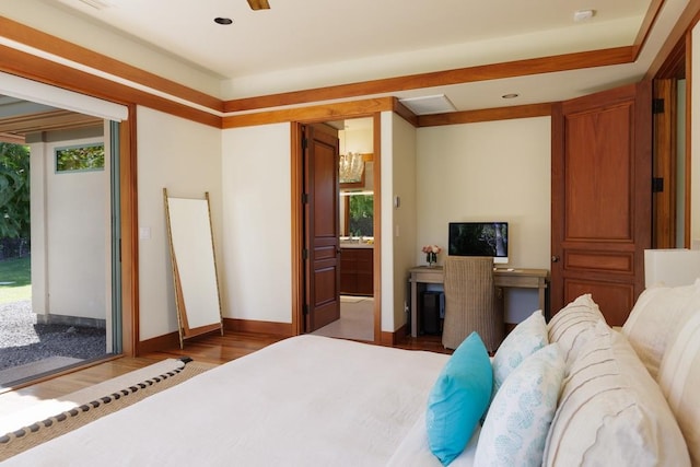 bedroom with wood finished floors and baseboards