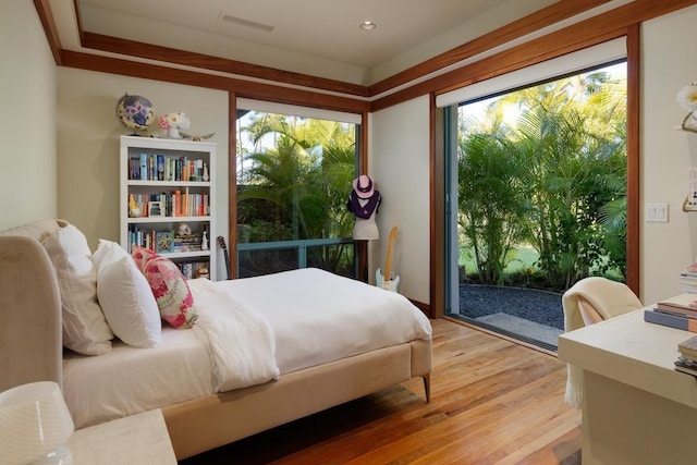 bedroom with light wood-style floors, access to exterior, and visible vents