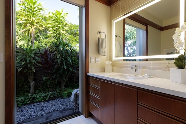 full bathroom featuring backsplash, vanity, and tile patterned floors