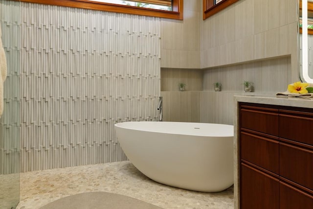 full bathroom featuring a freestanding bath and vanity