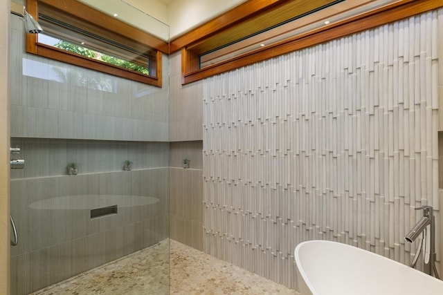 bathroom featuring a soaking tub and a walk in shower