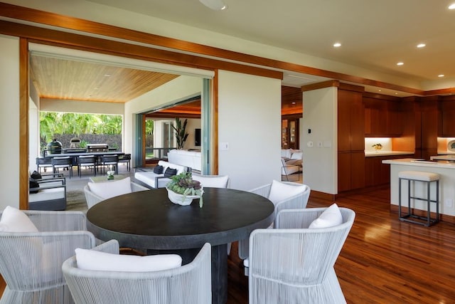 dining area with wood finished floors and recessed lighting