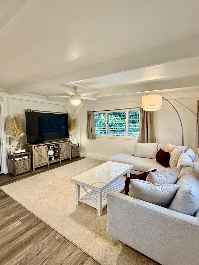 living room with wood finished floors and a ceiling fan